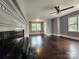 Living area featuring hardwood floors, fireplace, and lots of natural light at 3337 Eastway Dr, Charlotte, NC 28205