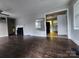 Cozy living room featuring a decorative fireplace, light walls, and worn hardwood floors at 3337 Eastway Dr, Charlotte, NC 28205