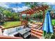 This backyard features a deck with a wooden pergola, furniture, a hammock, and a grassy yard at 1166 Montford Dr, Charlotte, NC 28209