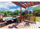 This backyard features a shaded deck and a hammock at 1166 Montford Dr, Charlotte, NC 28209