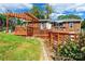 This backyard features a deck with a wooden pergola, a grassy yard, and a wooden fence at 1166 Montford Dr, Charlotte, NC 28209