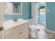 A bright bathroom features a white vanity, tile flooring, and soothing blue walls at 1166 Montford Dr, Charlotte, NC 28209