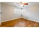 Bedroom featuring hardwood floors, natural light from windows, and a ceiling fan at 1166 Montford Dr, Charlotte, NC 28209