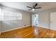 Bedroom featuring hardwood floors, natural light, ceiling fan, and an attached bathroom at 1166 Montford Dr, Charlotte, NC 28209