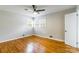 Bright bedroom with hardwood floors, neutral walls, ceiling fan and natural light from several windows at 1166 Montford Dr, Charlotte, NC 28209