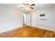 This bedroom features gleaming hardwood floors, a ceiling fan, and neutral paint at 1166 Montford Dr, Charlotte, NC 28209