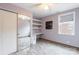 Bedroom with a large closet, built in shelves, and a small desk next to the window at 1166 Montford Dr, Charlotte, NC 28209