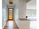 Welcoming foyer with hardwood floors, a striking white brick accent wall, and a contemporary lighting fixture at 1166 Montford Dr, Charlotte, NC 28209