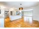 Open-concept kitchen features stainless steel appliances and a breakfast bar with hardwood floors at 1166 Montford Dr, Charlotte, NC 28209