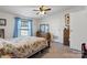 Comfortable bedroom with floral bedding and ceiling fan at 119 Loray Ln, Statesville, NC 28625