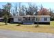 Single-story home with covered porch and landscaped yard at 119 Loray Ln, Statesville, NC 28625