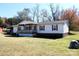 Single-story home with covered porch and landscaped yard at 119 Loray Ln, Statesville, NC 28625