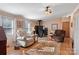 Bright living room with hardwood floors, wood burning stove, and comfy armchairs at 119 Loray Ln, Statesville, NC 28625