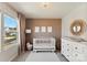 Bedroom with crib, dresser, and large window at 1547 Rye Rd, Mount Holly, NC 28120