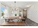 Bright dining room with a farmhouse table and entryway views at 1547 Rye Rd, Mount Holly, NC 28120