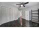 This bedroom features dark hardwood floors, neutral walls, a ceiling fan, and ample closet space at 26034 Misty Way Dr, Fort Mill, SC 29708