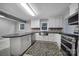 Modern kitchen featuring white cabinets, stainless steel appliances, and dark countertops at 26034 Misty Way Dr, Fort Mill, SC 29708