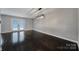 Bright living room features wood floors, a modern light fixture, and access to the outdoor space through glass doors at 26034 Misty Way Dr, Fort Mill, SC 29708