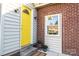 Side door entrance with yellow door and brick wall at 815 6Th Sw Ave, Hickory, NC 28602