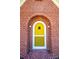 Charming yellow front door with brick accents at 815 6Th Sw Ave, Hickory, NC 28602