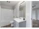 Well-lit bathroom features a shower-tub combo, grey vanity, and wood-look flooring at 1969 Beth Haven Church Rd, Denver, NC 28037