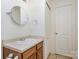 Bathroom features a modern sink with vanity, a mirror, and a ceramic-tiled floor at 135 Anastasia Ln, Lincolnton, NC 28092