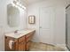 Well-lit bathroom showcases a wooden vanity with a sink, medicine cabinet, and tiled flooring at 135 Anastasia Ln, Lincolnton, NC 28092