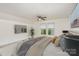 Comfortable bedroom features a ceiling fan, soft carpet, and bright windows for natural light at 135 Anastasia Ln, Lincolnton, NC 28092
