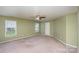 Expansive bedroom features a ceiling fan, neutral carpet, and good natural light from two windows at 135 Anastasia Ln, Lincolnton, NC 28092