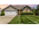 Beautiful home showcasing lush lawn, brick details, and attached two-car garage and attractive curb appeal at 135 Anastasia Ln, Lincolnton, NC 28092