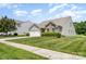 Charming home featuring manicured lawn, a two-car garage, brick accents, and lovely landscaping at 135 Anastasia Ln, Lincolnton, NC 28092