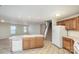 Bright kitchen features an island, tile flooring, and a view to the living area and staircase at 135 Anastasia Ln, Lincolnton, NC 28092