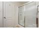 Bathroom with a clear glass sliding door shower and a white painted door at 135 Anastasia Ln, Lincolnton, NC 28092