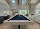 Well-lit game room with a pool table and lounge area, ideal for recreation and relaxation, with views of the lake at 4374 Morning Mist Dr # 25, Sherrills Ford, NC 28673