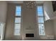 Bright living room features a modern fireplace, large windows and an elegant chandelier at 4374 Morning Mist Dr # 25, Sherrills Ford, NC 28673