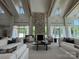 Inviting living room with stone fireplace, wood-beamed ceilings, and comfortable seating, bathed in natural light from large windows at 4374 Morning Mist Dr # 25, Sherrills Ford, NC 28673