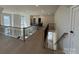 Second floor hallway with wood floors and metal railings looking down at front door at 4374 Morning Mist Dr # 25, Sherrills Ford, NC 28673