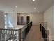 Open upstairs hallway with wood floors, metal railings, and recessed lighting at 4374 Morning Mist Dr # 25, Sherrills Ford, NC 28673