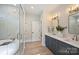 Bright bathroom with marble shower, modern vanity and double sinks at 571 Lyttleton Dr, Charlotte, NC 28211