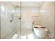 A modern glass shower room features marble and stylish fixtures at 571 Lyttleton Dr, Charlotte, NC 28211