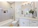 Bright bathroom featuring new fixtures, bathtub, white vanity and natural light at 571 Lyttleton Dr, Charlotte, NC 28211
