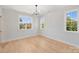 Bright bedroom featuring hardwood floors, and three large windows at 571 Lyttleton Dr, Charlotte, NC 28211