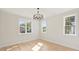 Bright bedroom featuring hardwood floors, and three large windows at 571 Lyttleton Dr, Charlotte, NC 28211