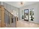 Stylish foyer featuring hardwood floors, paneled accent wall, modern light fixture and staircase at 571 Lyttleton Dr, Charlotte, NC 28211