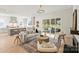 Well-lit living room with fireplace, hardwood floors, sliding glass doors, and a modern kitchen at 571 Lyttleton Dr, Charlotte, NC 28211