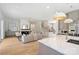 Open concept living room with hardwood floors, fireplace, and a view into the kitchen at 571 Lyttleton Dr, Charlotte, NC 28211