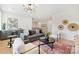 Modern living room featuring hardwood floors, fireplace, and comfortable seating at 571 Lyttleton Dr, Charlotte, NC 28211