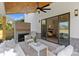 Inviting covered patio with a ceiling fan and a cozy brick fireplace for outdoor enjoyment at 571 Lyttleton Dr, Charlotte, NC 28211