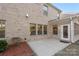 Brick patio adjacent to the house, with landscaping at 6602 Vizcaya Ct, Charlotte, NC 28226