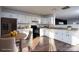 Bright kitchen featuring white cabinetry, modern black appliances, and a stylish eat-in dining area at 310 Foster Ln, Albemarle, NC 28001